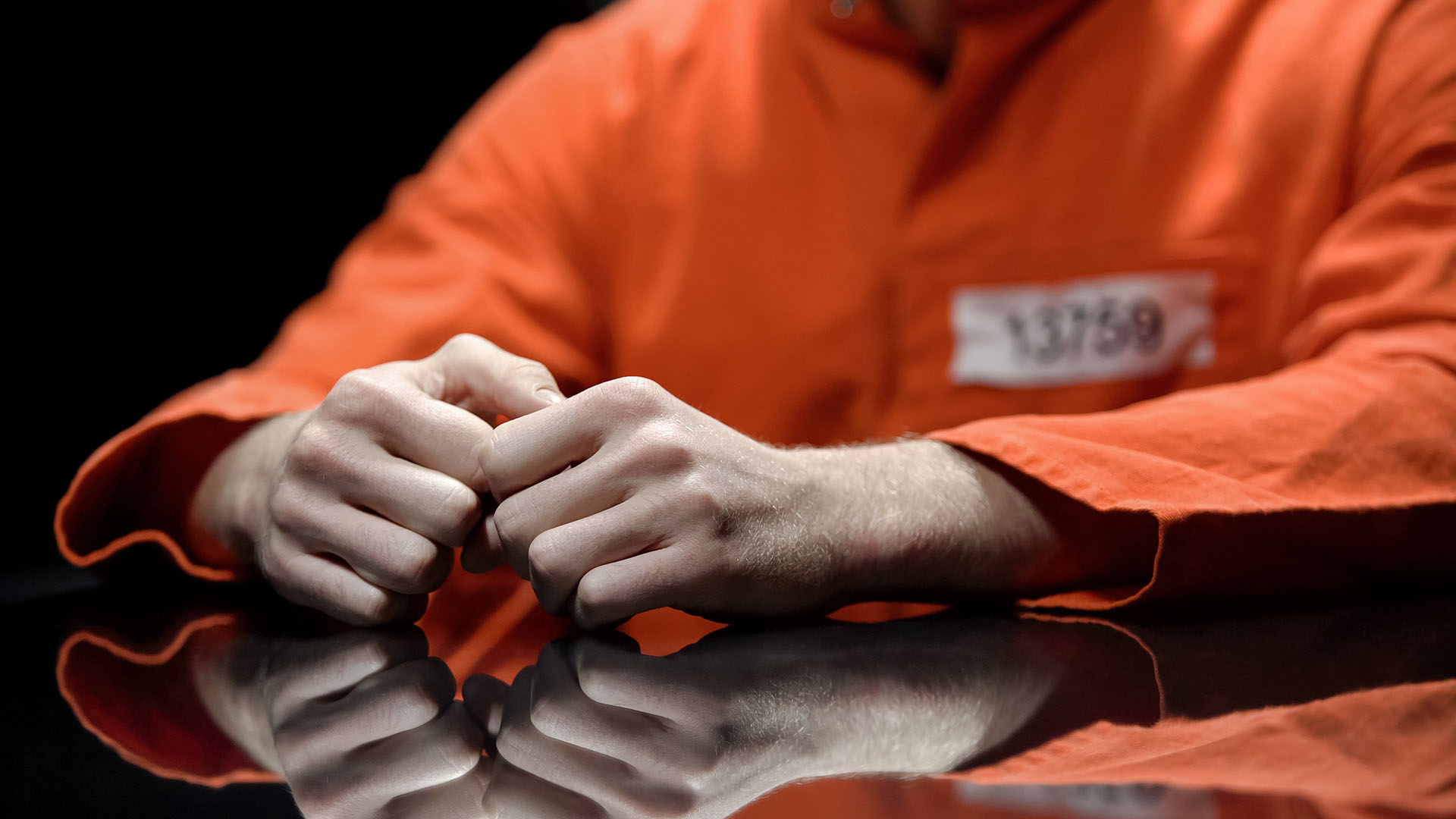 Arrested person hands closeup, prisoner talking to lawyer